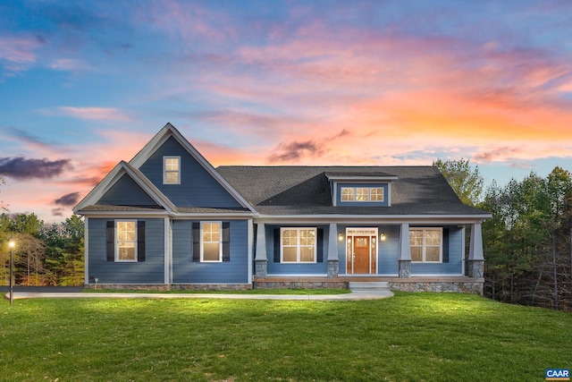 craftsman house with a porch and a front lawn