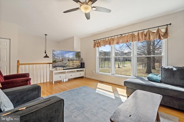 living area with ceiling fan and wood finished floors