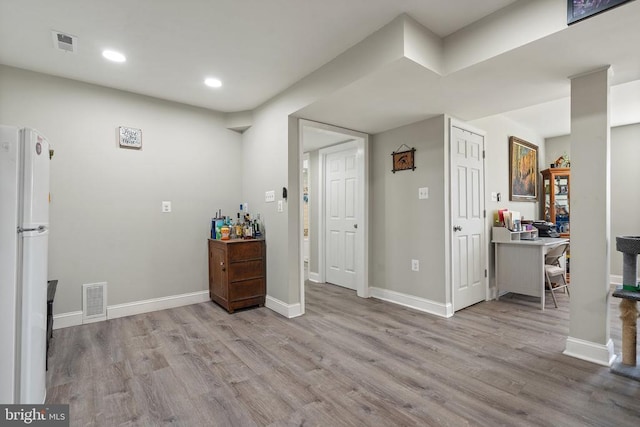 interior space featuring recessed lighting, visible vents, baseboards, and wood finished floors