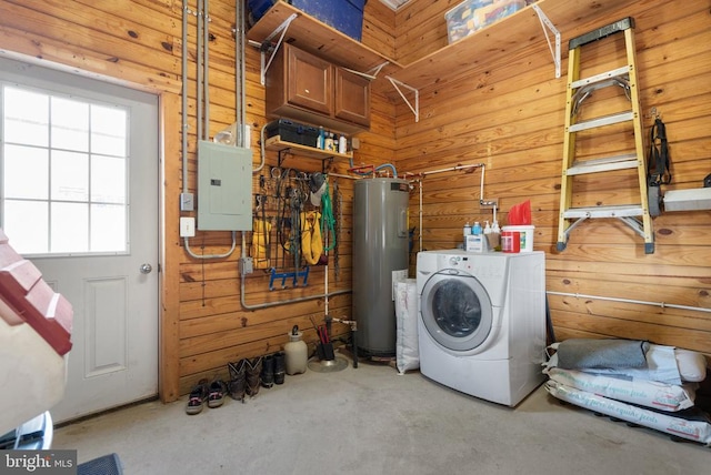 washroom with electric panel, washer / clothes dryer, electric water heater, wood walls, and laundry area