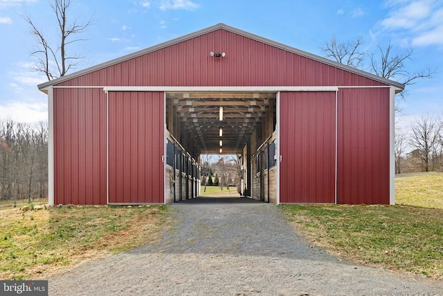 view of pole building with a carport and aphalt driveway