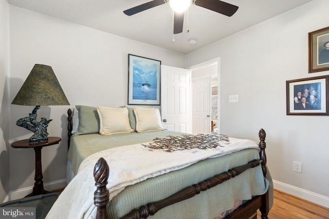 bedroom featuring ceiling fan, baseboards, and wood finished floors