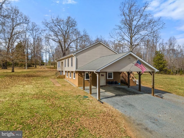 view of property exterior featuring stairs, a carport, a yard, and driveway