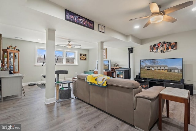 living room featuring recessed lighting, wood finished floors, baseboards, and ceiling fan