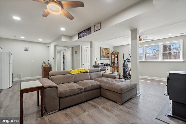 living area featuring visible vents, baseboards, ceiling fan, recessed lighting, and light wood-style floors