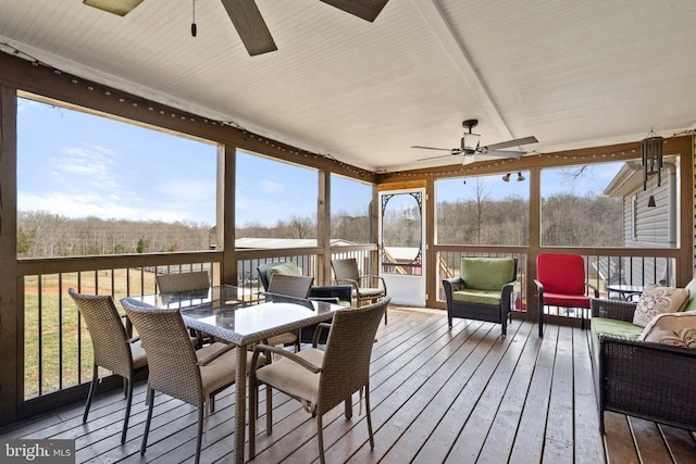 sunroom with a healthy amount of sunlight and ceiling fan