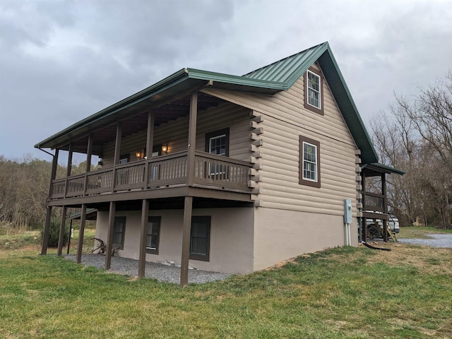 view of home's exterior featuring a wooden deck and a yard