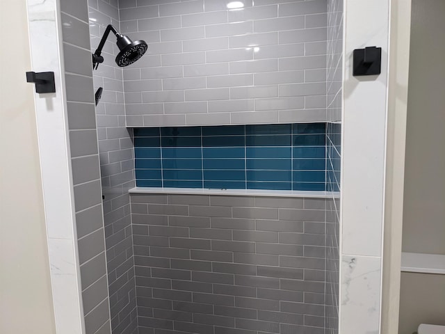 bathroom with a tile shower