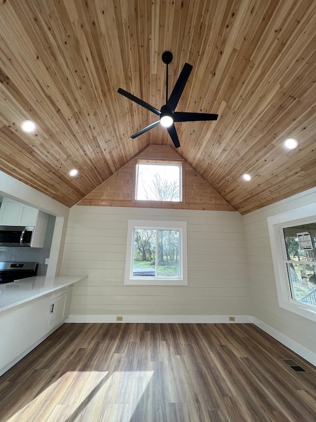 additional living space featuring dark hardwood / wood-style flooring, wood ceiling, lofted ceiling, and ceiling fan