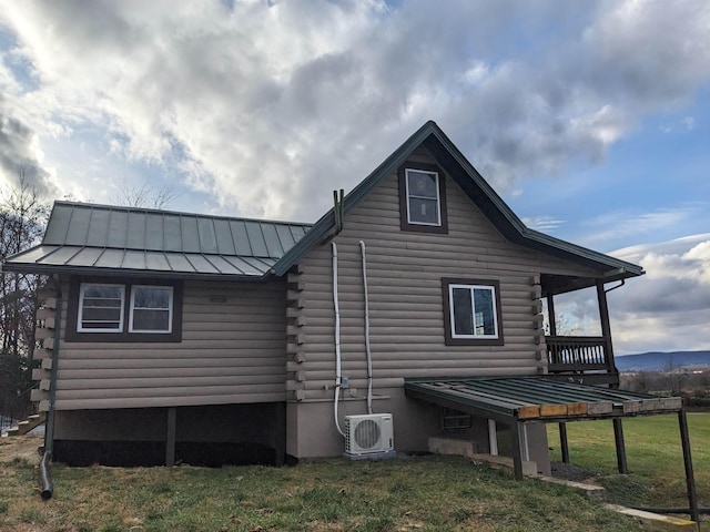 view of side of property featuring a lawn and ac unit