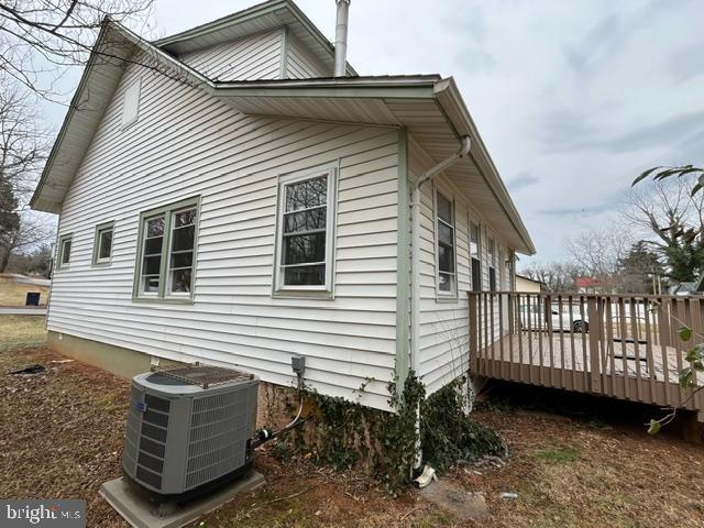 view of home's exterior with central AC unit and a deck