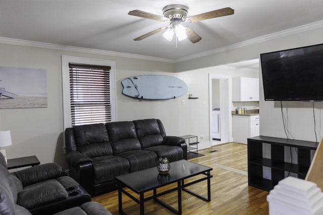 living room with ornamental molding, ceiling fan, and light wood-type flooring