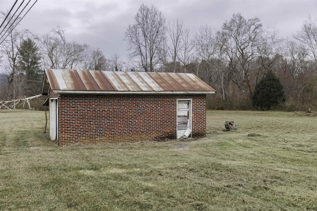 view of outbuilding with a lawn