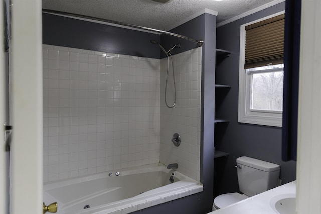 full bathroom with sink, crown molding, tiled shower / bath combo, a textured ceiling, and toilet