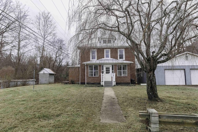 view of front of house with a garage, a shed, and a front yard