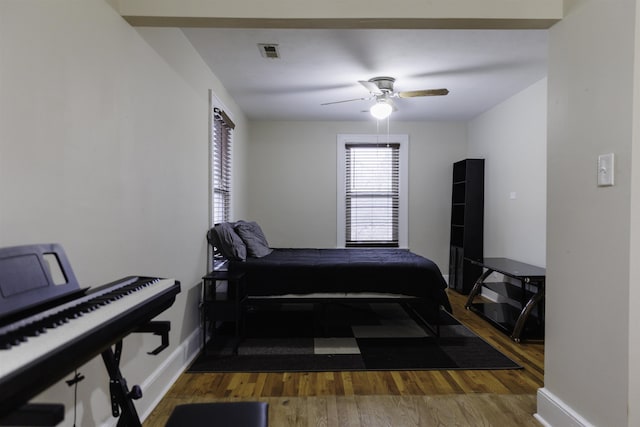 bedroom featuring dark hardwood / wood-style flooring and ceiling fan