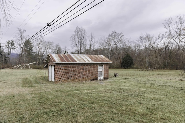 view of yard featuring a garage and an outbuilding