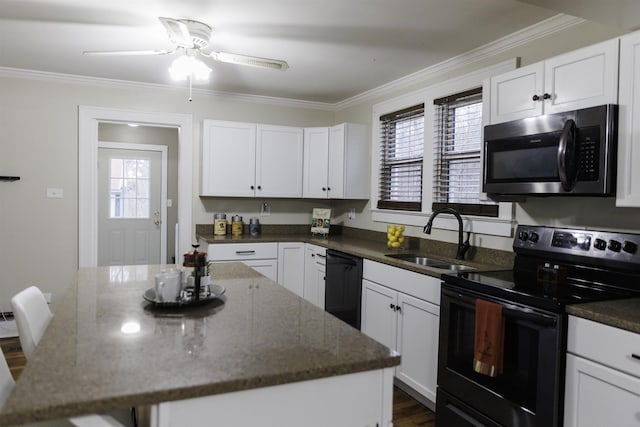 kitchen with electric stove, black dishwasher, and white cabinets