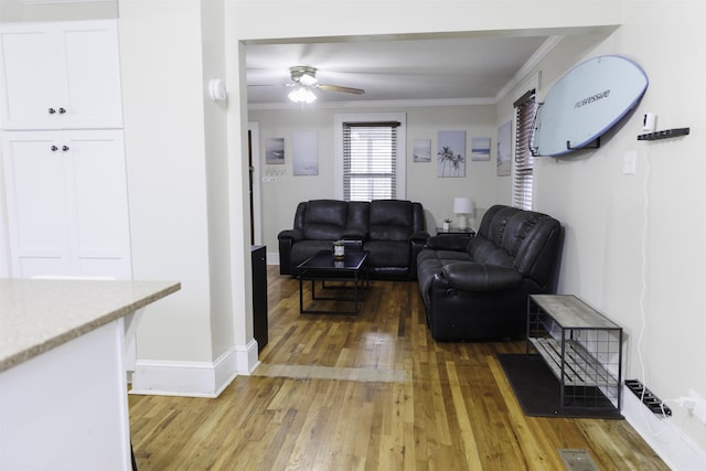 living room featuring crown molding, ceiling fan, and hardwood / wood-style flooring