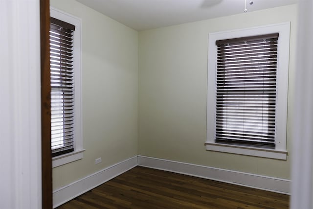 unfurnished room featuring dark hardwood / wood-style flooring