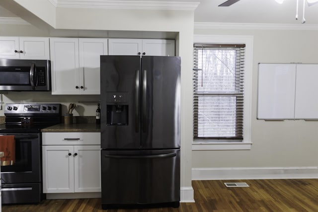 kitchen with stainless steel appliances, ornamental molding, white cabinets, and dark hardwood / wood-style flooring