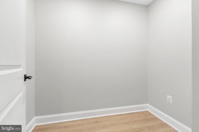 spare room featuring crown molding, light hardwood / wood-style flooring, and french doors