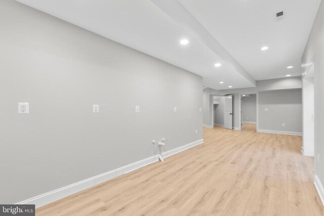 basement with light hardwood / wood-style flooring