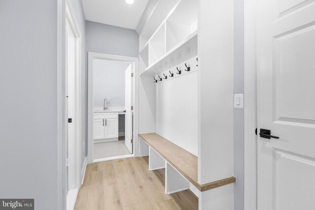 mudroom featuring sink and light hardwood / wood-style floors