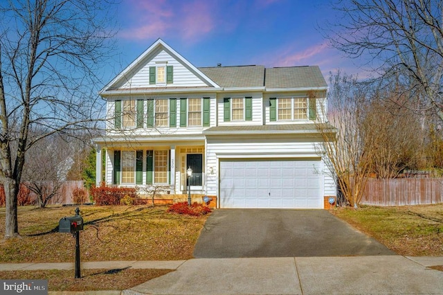 view of front of property with fence, driveway, and an attached garage