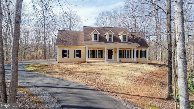 cape cod home with a porch