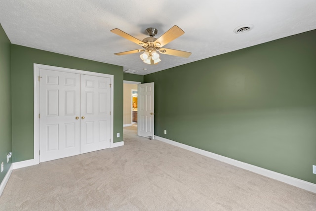 unfurnished bedroom featuring carpet flooring, baseboards, visible vents, and a closet