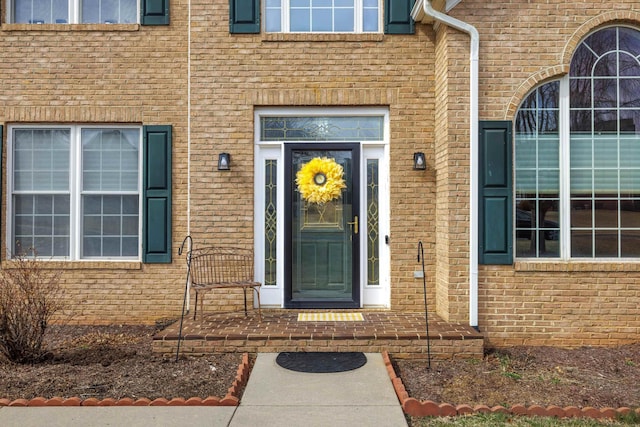 property entrance featuring brick siding