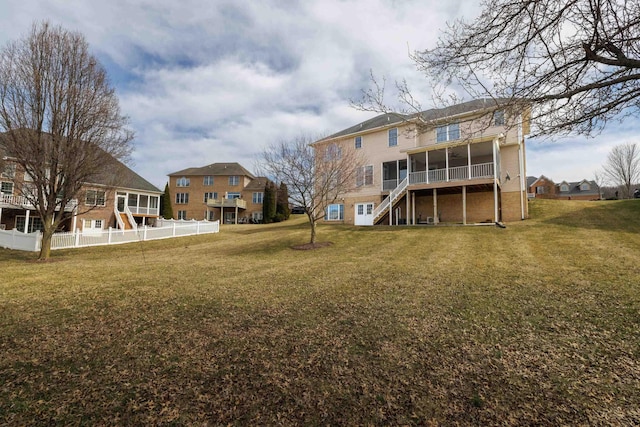 view of yard with fence and a sunroom