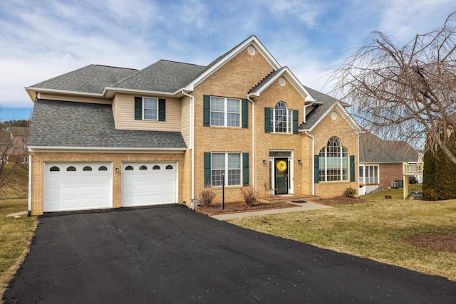 view of front of house featuring driveway, a shingled roof, a front lawn, a garage, and brick siding