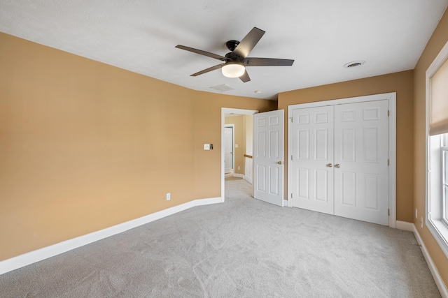 unfurnished bedroom with visible vents, carpet, and baseboards