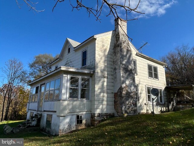 view of home's exterior with a yard