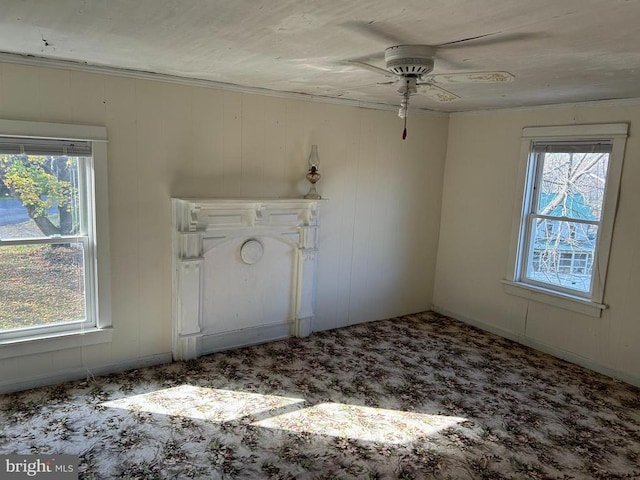 carpeted spare room featuring plenty of natural light