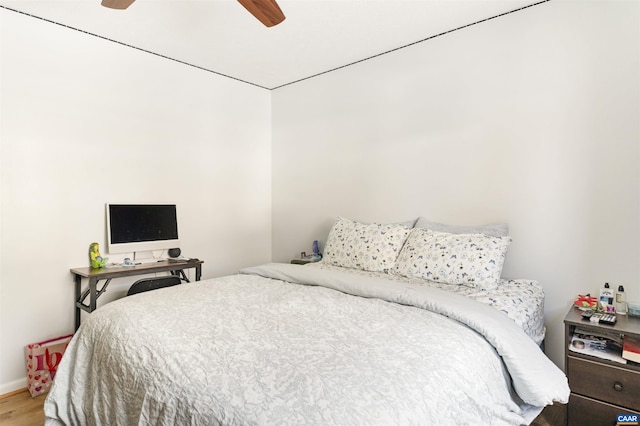 bedroom with a ceiling fan and wood finished floors