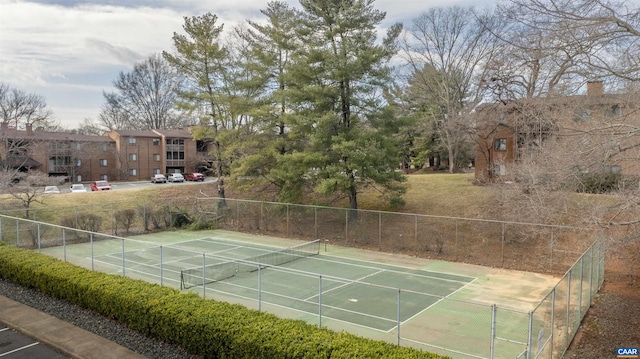 view of tennis court featuring fence