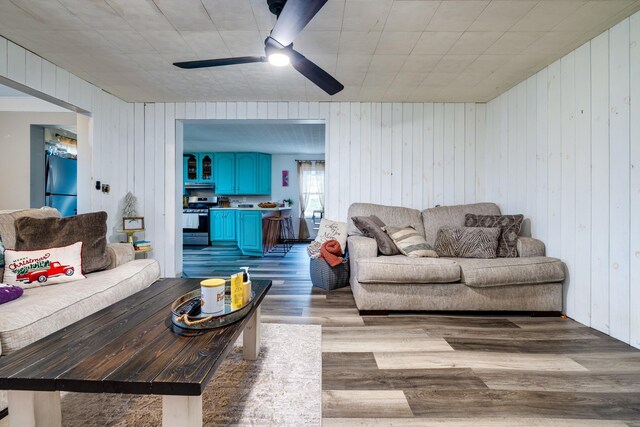 living room with ceiling fan and light wood-type flooring