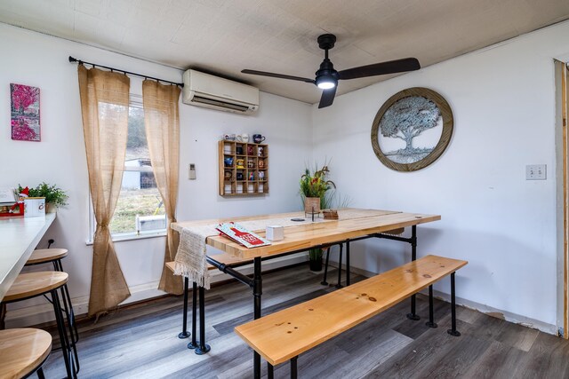 dining space with dark hardwood / wood-style flooring, ceiling fan, and a wall unit AC