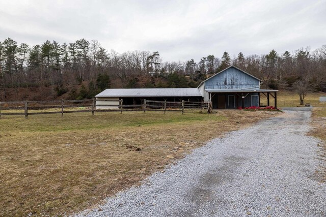 view of stable with a rural view