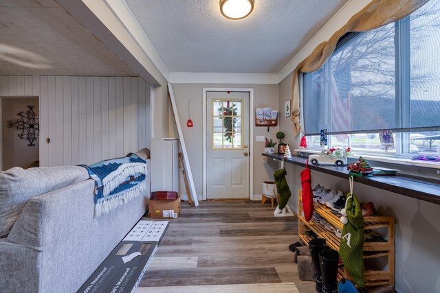 entryway with hardwood / wood-style floors and a textured ceiling