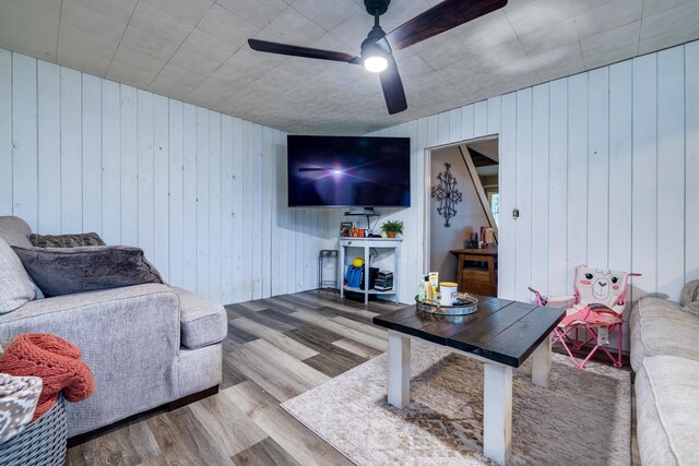 living room featuring hardwood / wood-style floors and ceiling fan