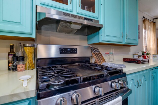 kitchen featuring blue cabinets and gas stove