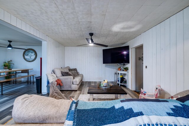 living room with ceiling fan and wood-type flooring