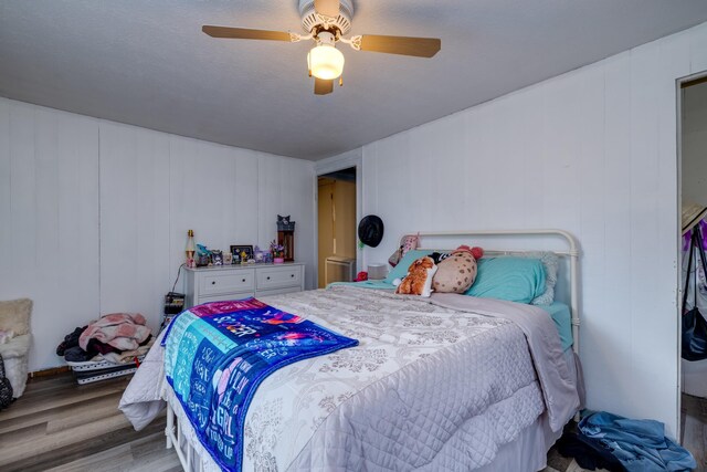 bedroom with ceiling fan and light wood-type flooring