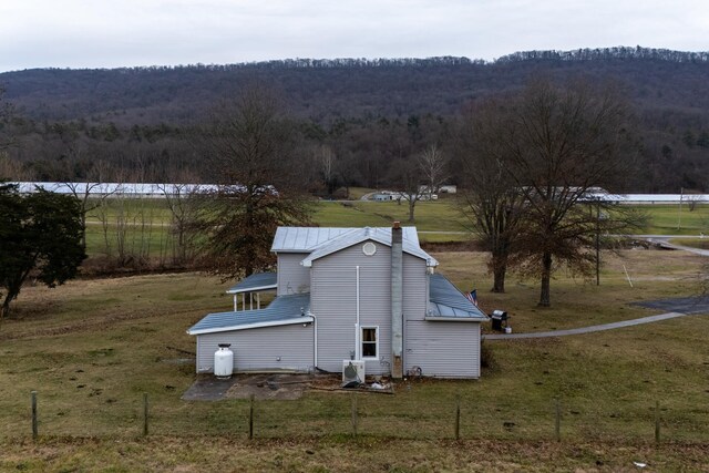 exterior space featuring a yard and a rural view