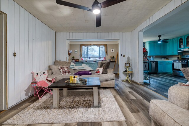 living room featuring wood-type flooring and ceiling fan