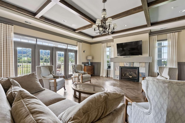 living room with parquet flooring, coffered ceiling, crown molding, a tile fireplace, and beam ceiling